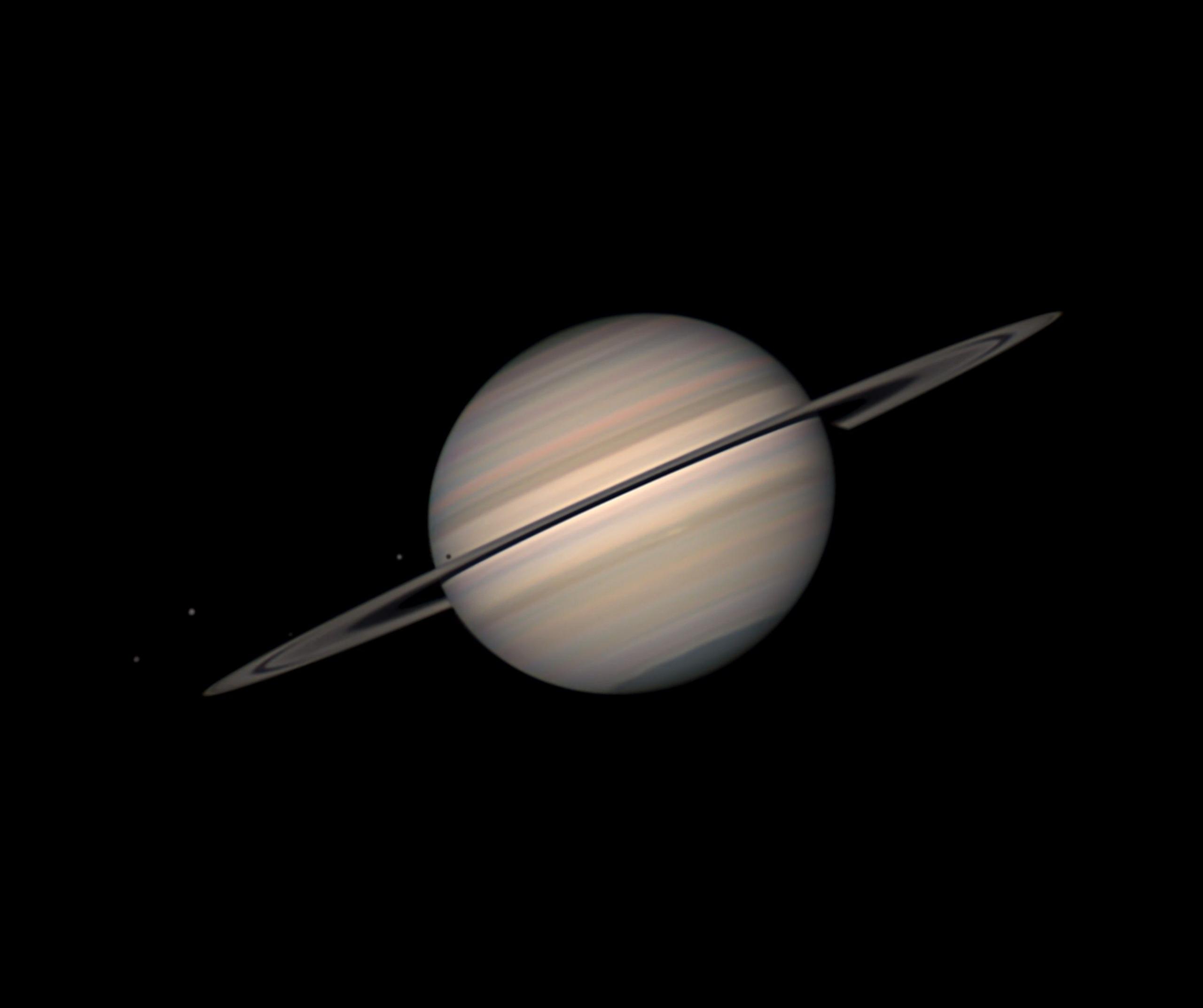 The planet Saturn pictured against the black background of space.