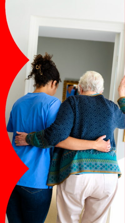 A female nurse helping an elderly woman walk