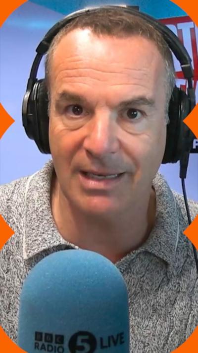 A man wearing headphones talks into a microphone