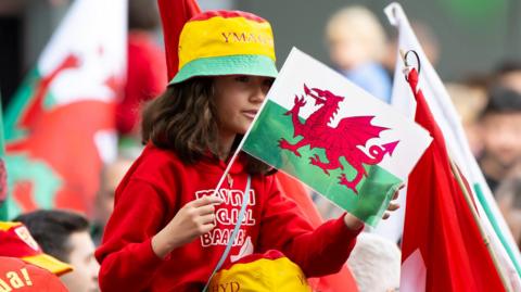 A young girl with a Wales flag