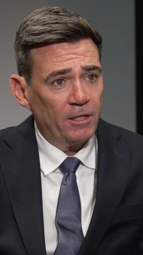 Andy Burnham in a navy suit, white shirt and navy tie. 