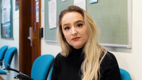 Presenter Ellie Colton in a hospital waiting room