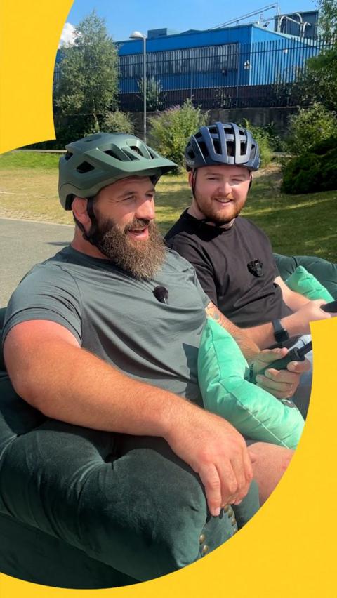 Joe Marler and Alex Fletcher sat on a sofa bike