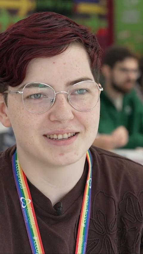 Close-up young woman with short dark brown hair and round glasses