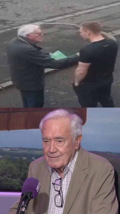An older man holding a leaflet shakes the hand of a younger man who is a personal trainer.