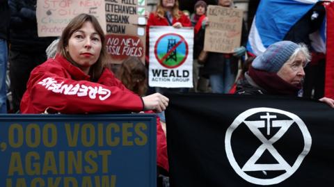 Protestors with placards and banners outside the Court of Session in Edinburgh.