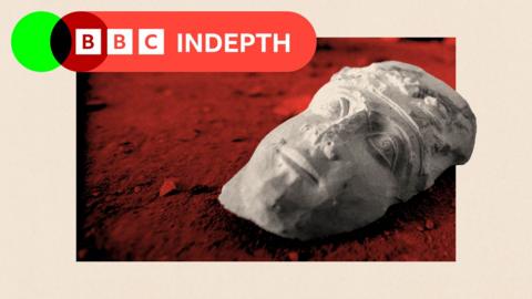 The face of a statue lies on the ground at the destroyed museum in the ancient Syrian city of Palmyra