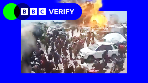 Missile strikes crowded market with cars and people surrounding the area. There is blue and green BBC Verify branding on the top left.