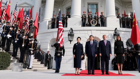 President Xi and President Trump outside the White House with guards in uniform and and flags 