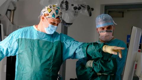Consultant neurosurgeon Mr Stuart Smith is in the operating theatre doing surgery on Steve