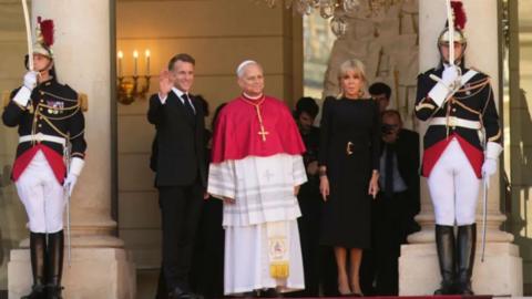 Pope Leo XIV with Emmanuel Macron to his right and Brigitte Macron to his left.