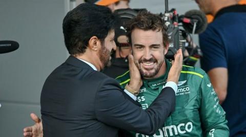FIA president Mohammed Ben Sulayem embraces Fernando Alonso in parc feme during the 2024 Azerbaijan Grand Prix in Baku