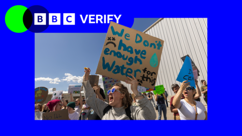 A woman protesting against the expansion of data centres in the US holds a placard reading 'We don't have enough water'