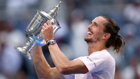 Alexander Zverev celebrates with the US Open trophy