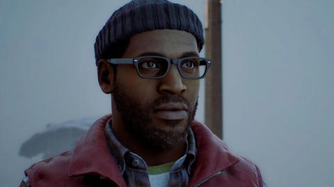 An in-game screenshot of protagonist Simon, wearing a blue beanie and red gilet. He has black glasses and a black beard and is staring off screen.