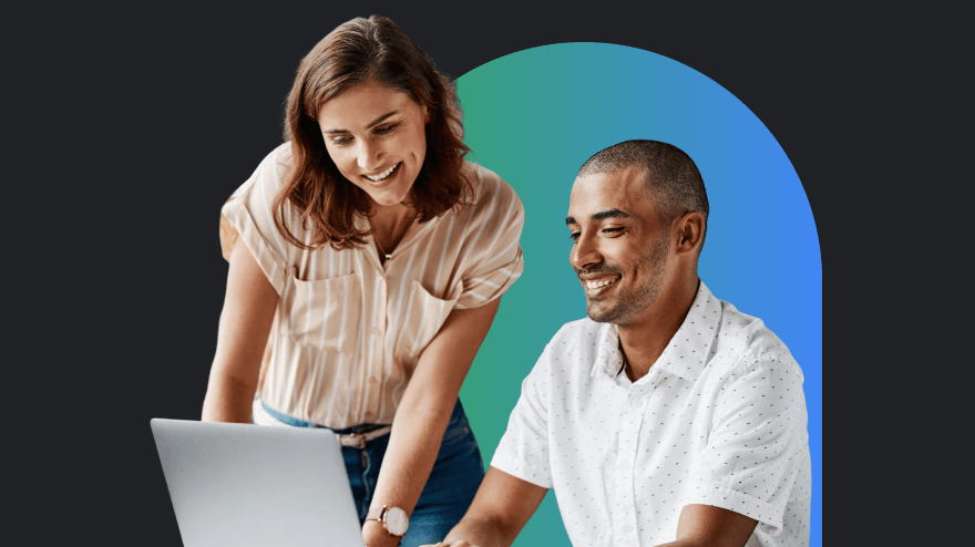 A woman and a man working on a laptop together.