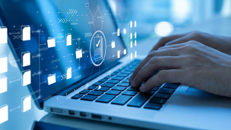 Hands typing on a laptop