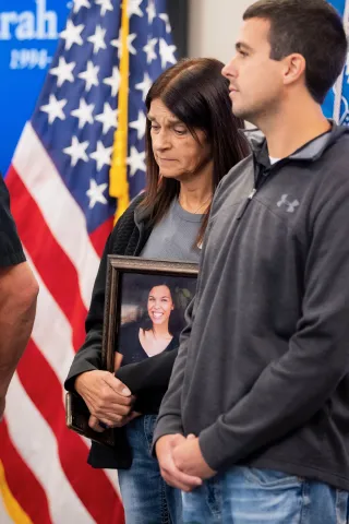 Angel Family, Sarah Root’s mother Michelle holding her portrait