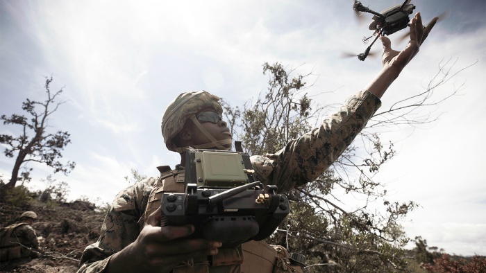 Marine Corps Lance Cpl. Dmitri Shepherd launches a drone while conducting the infantry platoon battle course during Bougainville II at Pohakuloa Training Area, Hawaii, Oct. 17, 2021
