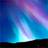 extrapenguin: Northern lights in blue and purple above black horizon. (Default)